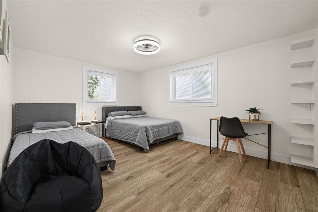 219 Coral Road Venice, FL 34293 - Photo 16 of 24 a bedroom with two beds and a chair