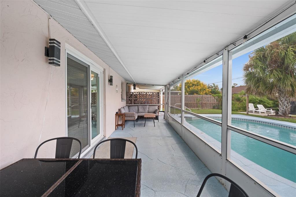 219 Coral Road Venice, FL 34293 - Photo 18 of 24 a view of a swimming pool with outdoor seating