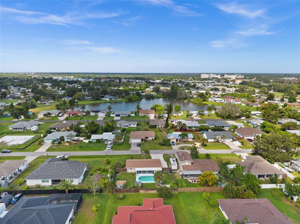 219 Coral Road Venice, FL 34293 - Photo 3 of 24 an aerial view of a city with lots of residential buildings ocean and mountain view in back