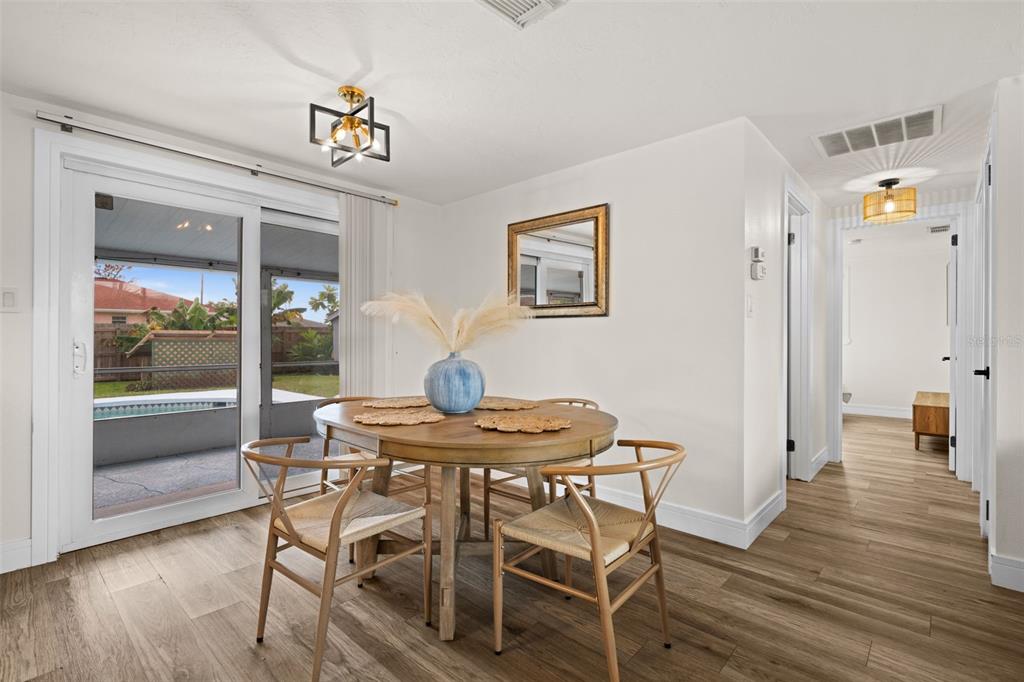 219 Coral Road Venice, FL 34293 - Photo 7 of 24 a view of a dining room with furniture window and wooden floor