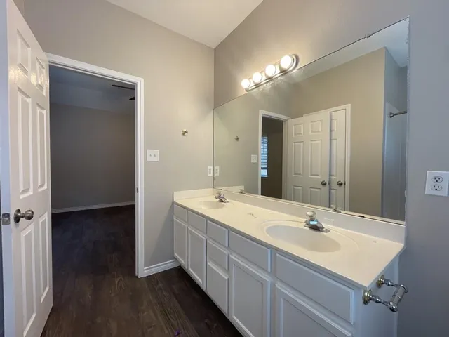 a bathroom with a sink double vanity and a mirror