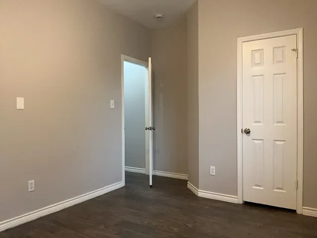 an empty room with closet area