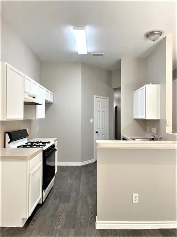 a kitchen with a stove and a refrigerator