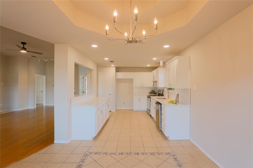 3616 Sutter Court Fort Worth, TX 76137 - Photo 12 of 28 a view of a kitchen with kitchen island a sink stainless steel appliances and cabinets