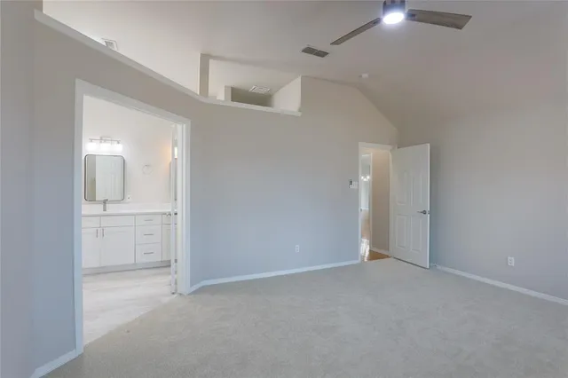 wooden floor in an empty room with a kitchen