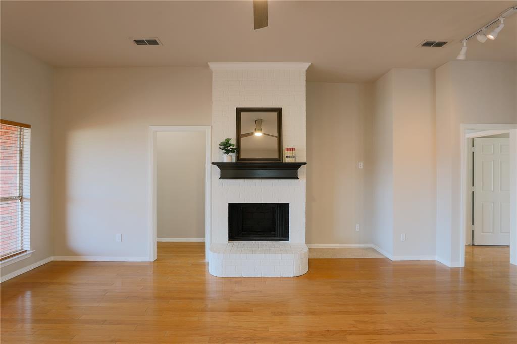 3616 Sutter Court Fort Worth, TX 76137 - Photo 4 of 28 a living room with a fireplace
