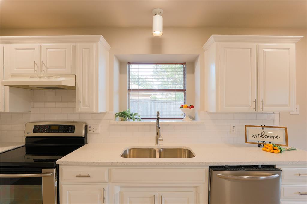 3616 Sutter Court Fort Worth, TX 76137 - Photo 8 of 28 a kitchen with a sink a stove cabinets and a window