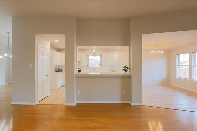 a view of a big room with wooden floor and a bathroom