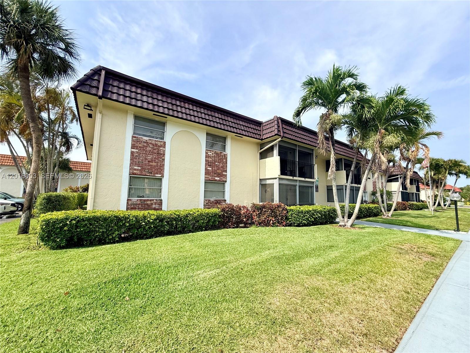 22805 Southwest 66th Avenue, Unit 208 Boca Raton, FL 33428 - Photo 11 of 28 a view of a house with a yard