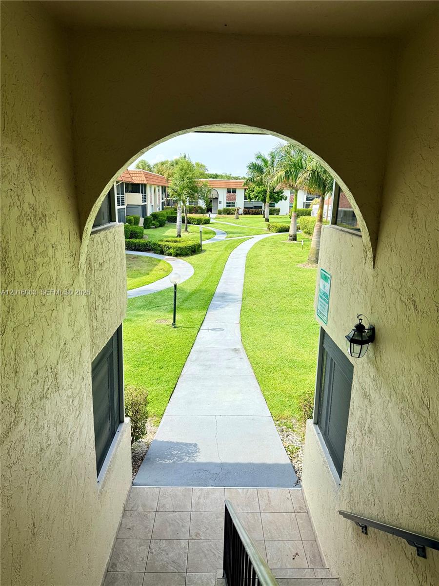 22805 Southwest 66th Avenue, Unit 208 Boca Raton, FL 33428 - Photo 13 of 28 a view of swimming pool with a garden and plants