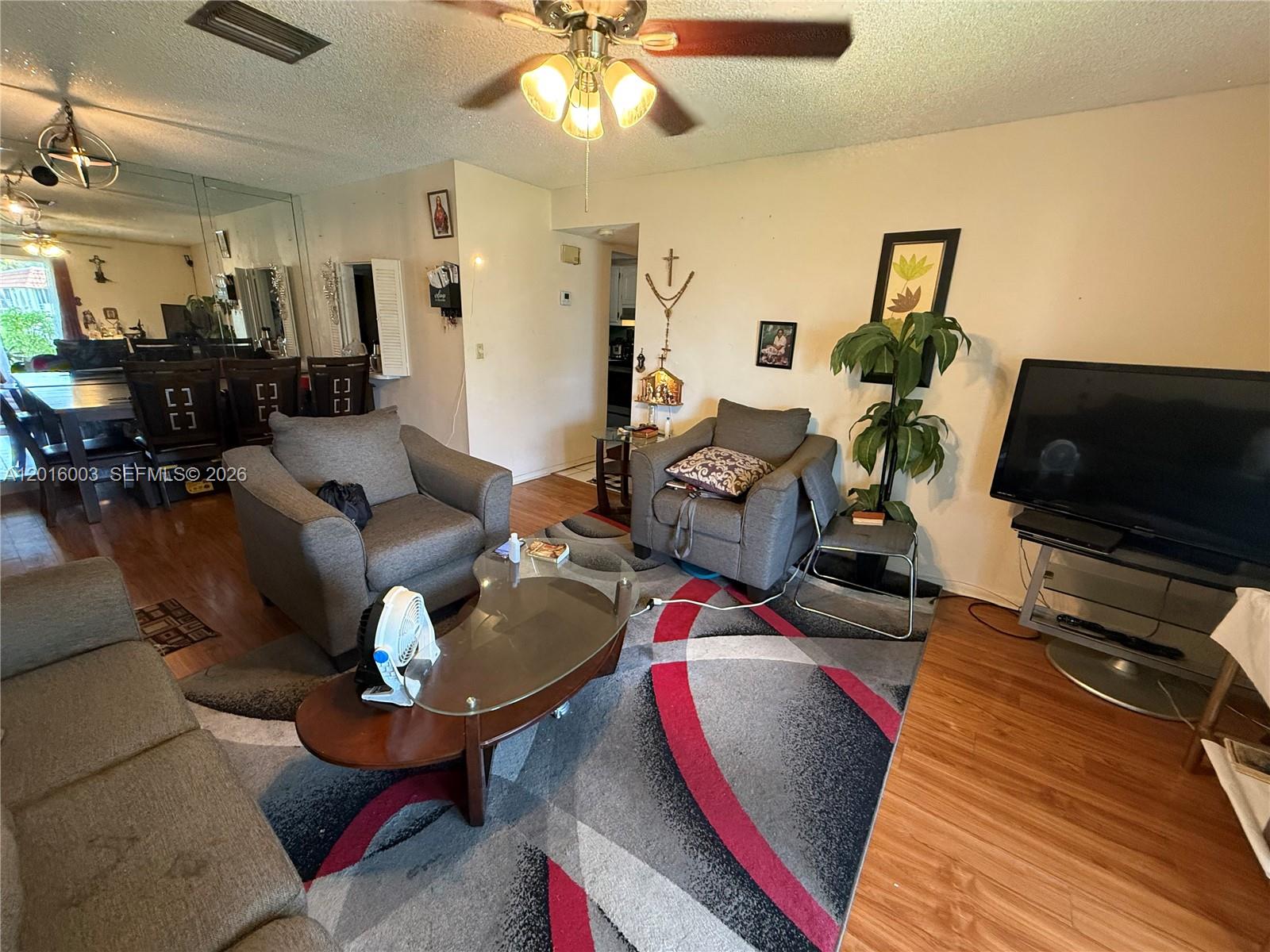22805 Southwest 66th Avenue, Unit 208 Boca Raton, FL 33428 - Photo 16 of 28 a living room with furniture and a flat screen tv