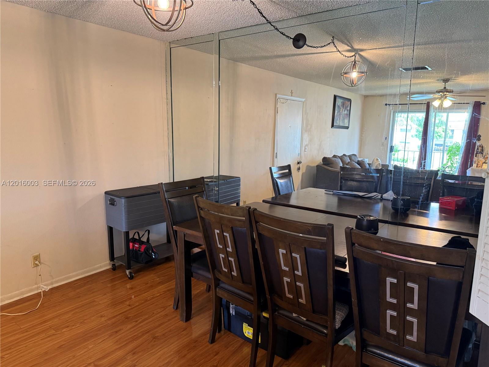 22805 Southwest 66th Avenue, Unit 208 Boca Raton, FL 33428 - Photo 17 of 28 a living room with stainless steel appliances furniture a dining table and chairs with wooden floor