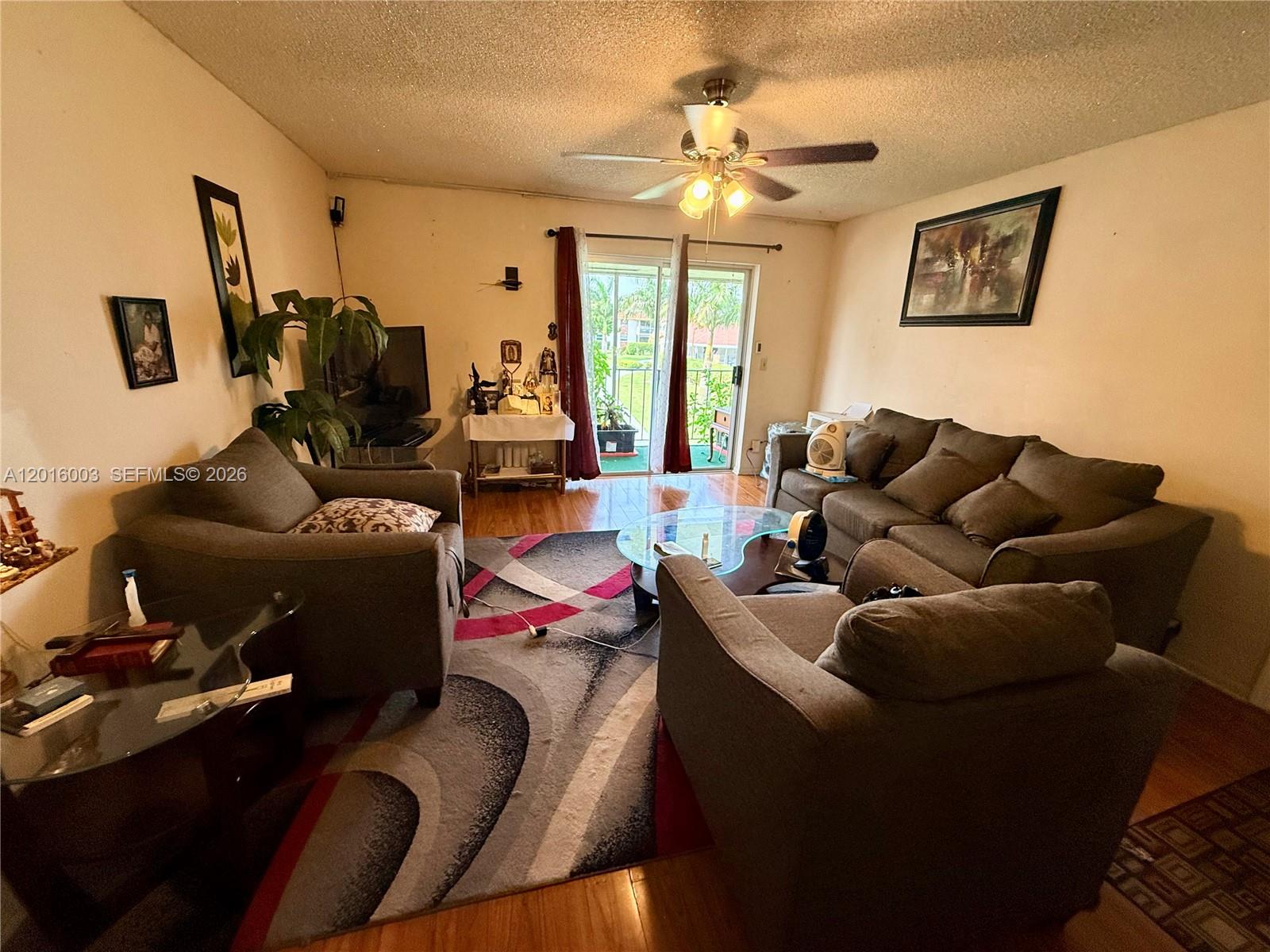 22805 Southwest 66th Avenue, Unit 208 Boca Raton, FL 33428 - Photo 18 of 28 a living room with furniture and a large window
