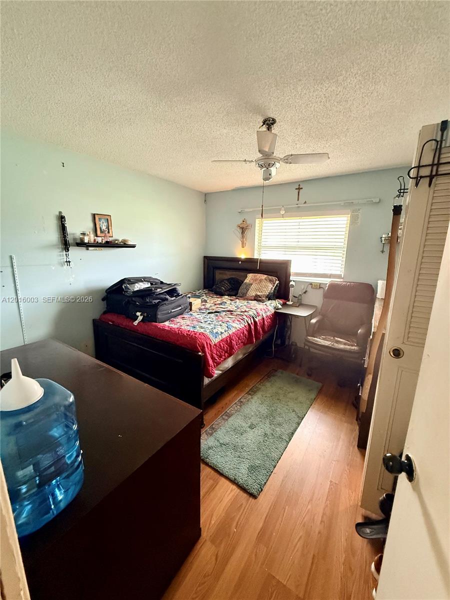22805 Southwest 66th Avenue, Unit 208 Boca Raton, FL 33428 - Photo 19 of 28 a bedroom with bed couch and window