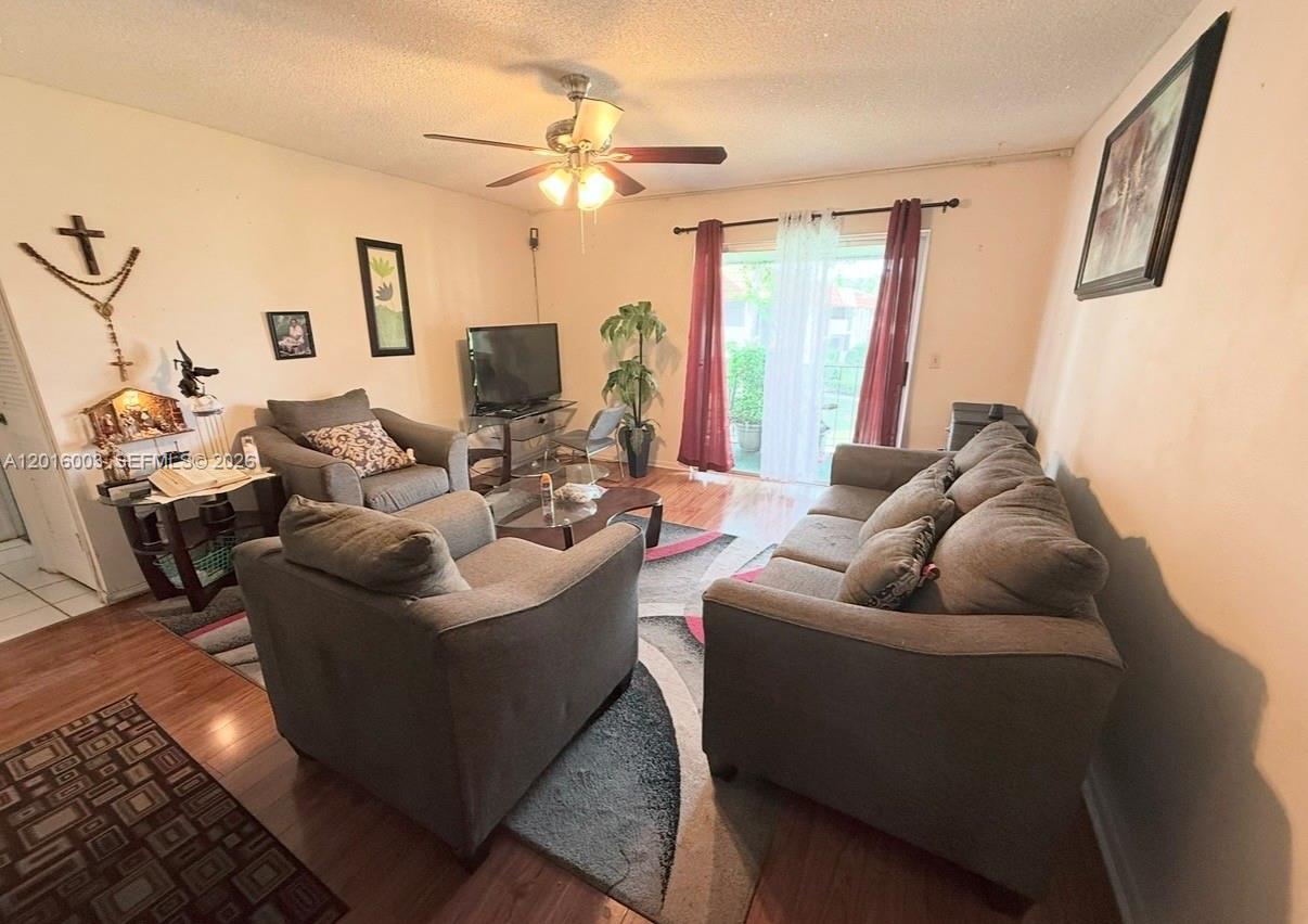 22805 Southwest 66th Avenue, Unit 208 Boca Raton, FL 33428 - Photo 24 of 28 a living room with furniture and a large window