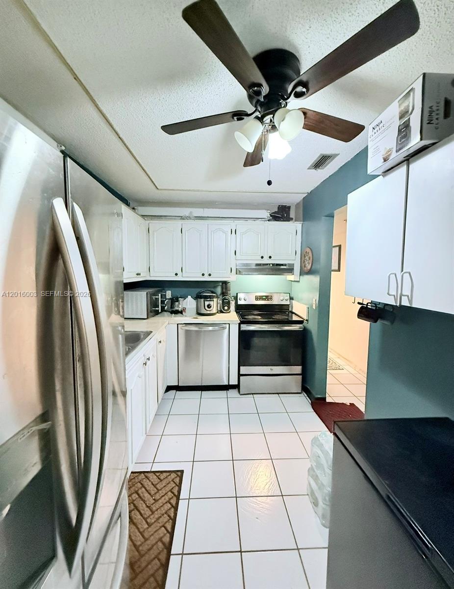 22805 Southwest 66th Avenue, Unit 208 Boca Raton, FL 33428 - Photo 28 of 28 a kitchen with cabinets and stainless steel appliances