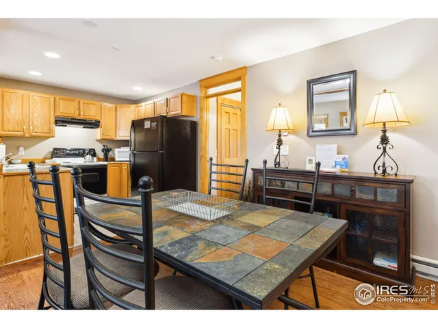 a kitchen view with a table and chairs
