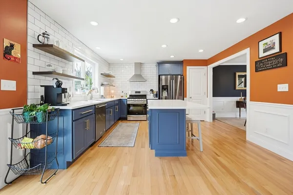 a large kitchen with stainless steel appliances kitchen island granite countertop a large counter top and breakfast area