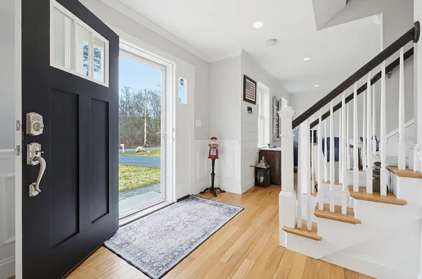 a view of an entryway with wooden floor