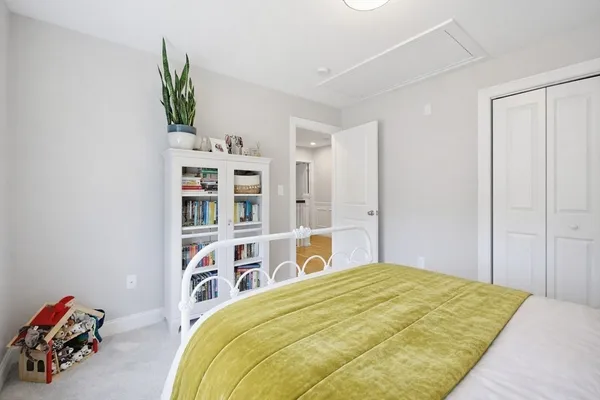 a bedroom with a bed and a book shelf
