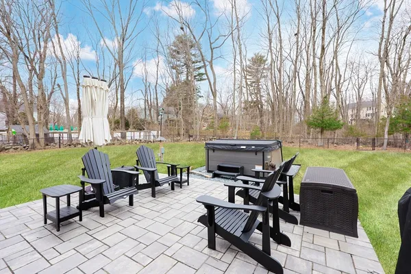 a view of a swimming pool and lounge chairs in back yard