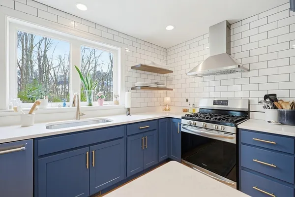 a kitchen with a sink stove and cabinets
