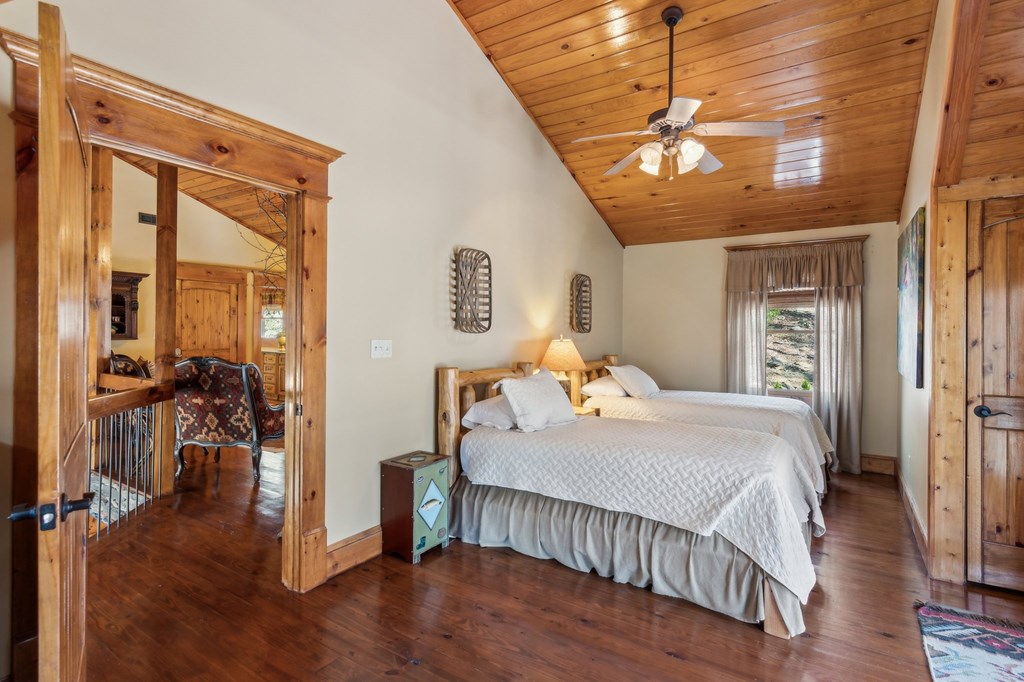 124 River Shoals Road Ellijay, GA 30536 - Photo 26 of 57 a bedroom with a bed and wooden floor