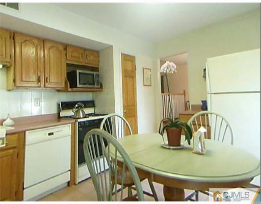 148 Howard Avenue Edison, NJ 08837 - Photo 12 of 19 a kitchen with a stove a sink and a microwave