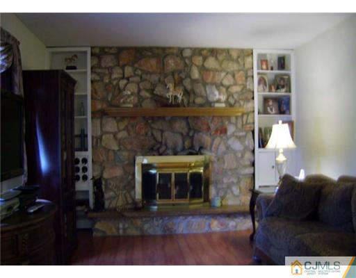 148 Howard Avenue Edison, NJ 08837 - Photo 13 of 19 a living room with furniture and a fireplace
