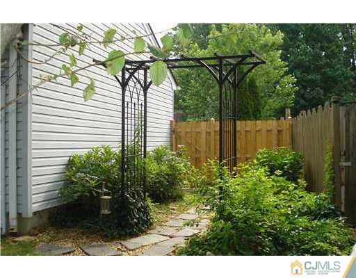 148 Howard Avenue Edison, NJ 08837 - Photo 14 of 19 a view of a garden with a house