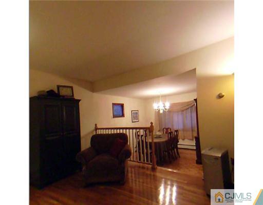 148 Howard Avenue Edison, NJ 08837 - Photo 16 of 19 a living room with furniture and wooden floor