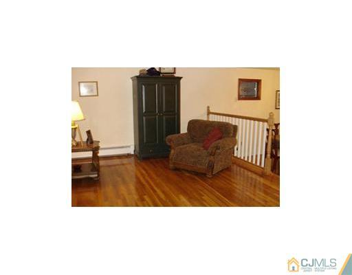 148 Howard Avenue Edison, NJ 08837 - Photo 17 of 19 a living room with furniture and a refrigerator