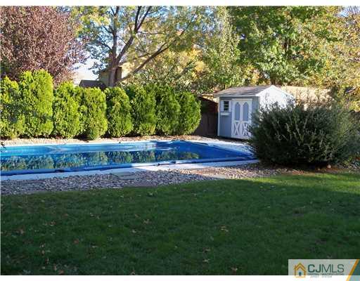 148 Howard Avenue Edison, NJ 08837 - Photo 6 of 19 a view of house with backyard and trees