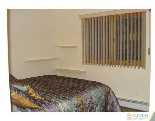148 Howard Avenue Edison, NJ 08837 - Photo 7 of 19 a bedroom with a bed