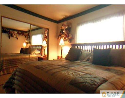148 Howard Avenue Edison, NJ 08837 - Photo 10 of 19 a bedroom with a bed and a window