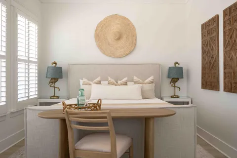 a living room with furniture and floor to ceiling windows