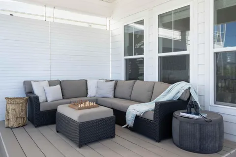a view of a house with pool and chairs