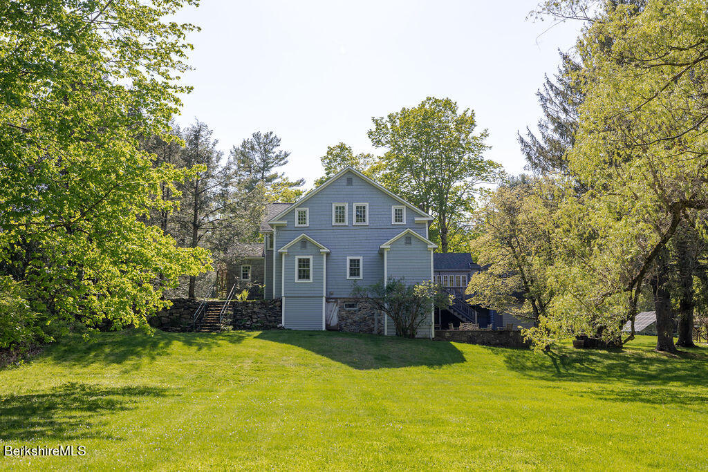 17 Cronk Road Monterey, MA 01245 - Photo 67 of 79 a front view of a house with a yard garage and outdoor seating