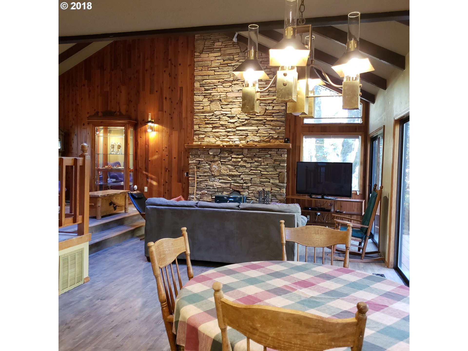 65707 East Barlow Trail Road Rhododendron, OR 97049 - Photo 11 of 32 a view of a dining room with furniture and a chandelier
