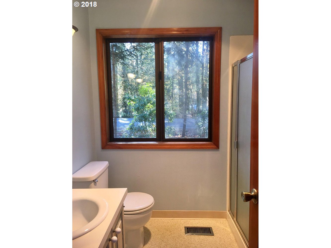 65707 East Barlow Trail Road Rhododendron, OR 97049 - Photo 23 of 32 a bathroom with a toilet a sink and a window