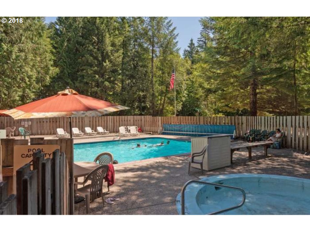 65707 East Barlow Trail Road Rhododendron, OR 97049 - Photo 31 of 32 a backyard of a house with table and chairs