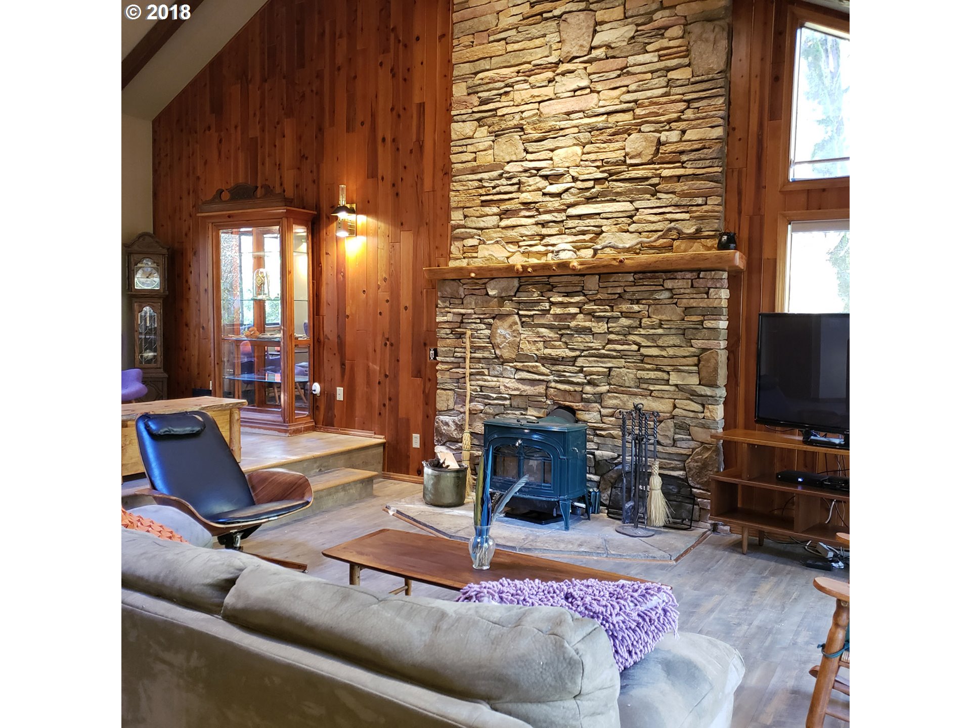 65707 East Barlow Trail Road Rhododendron, OR 97049 - Photo 6 of 32 a living room with furniture a fireplace and a flat screen tv