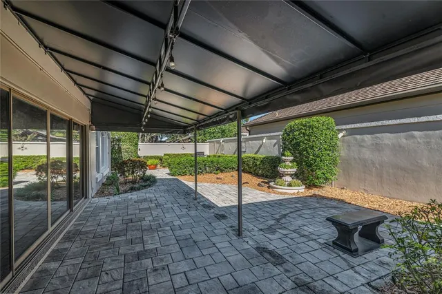 a view of a backyard with table and chairs
