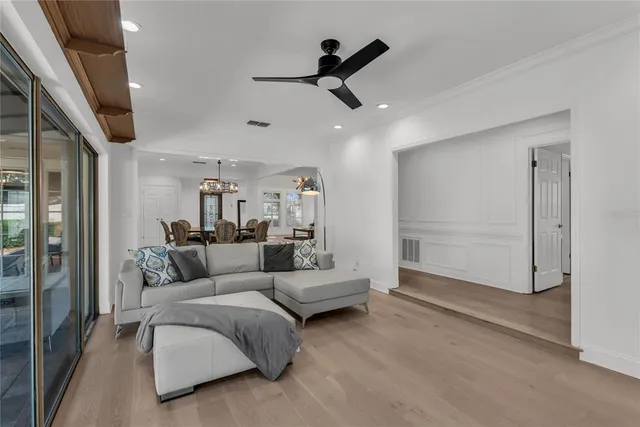 a living room with furniture and a ceiling fan