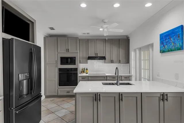 a kitchen with kitchen island a sink stainless steel appliances and cabinets