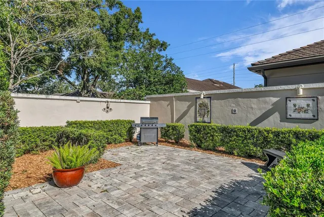 a front view of a house with a yard and potted plants