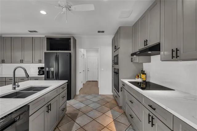 a kitchen filled a sink a refrigerator and cabinets