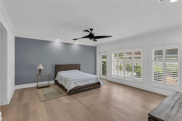 a spacious bedroom with a bed and a large window