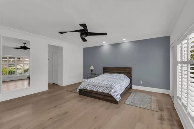 a spacious bedroom with a bed and a window