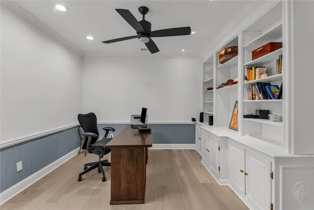 a view of a workspace with furniture and a book shelf